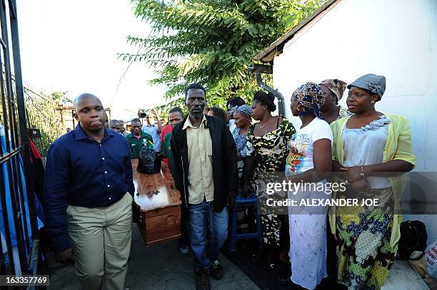 Relatives and friends carry the coffin of Mido Macia to his home in Daveyton on March 8, 2013 for people to pay their last respects before the coffin...