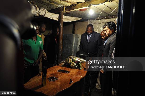 Joseph Macia , the father of Mido Macia, looks at his son's coffin of Mido Macia at his home in Daveyton on March 8, 2013. Nine South African...