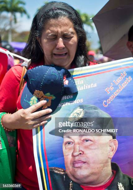 Supporter of late President Hugo Chavez weeps outside of his funeral in Caracas, on March 8, 2013. Late Venezuelan president Hugo Chavez will be...