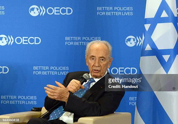 In this handout supplied by the the Israeli Government press office , Israeli President Shimon Peres speaks at the OECD on March 8, 2013 in Paris,...