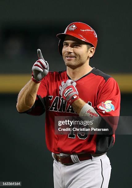 Joey Votto of Canada reacts after hitting a long foul ball during the first inning of the World Baseball Classic First Round Group D game against...