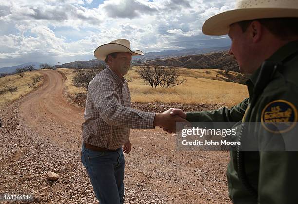 Cattle rancher Dan Bell greets U.S. Border Patrol ranch liaison agent John "Cody" Jackson on Bell's ZZ Cattle Ranch along the U.S.-Mexico border on...