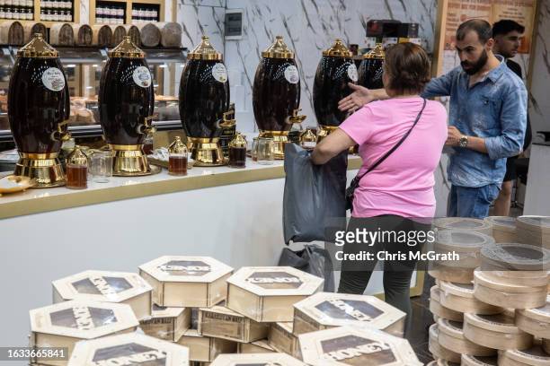 An employee sells Turkish honey products to tourists at a high-end honey shop on August 23, 2023 in Istanbul, Turkey. Turkey is the world's second...