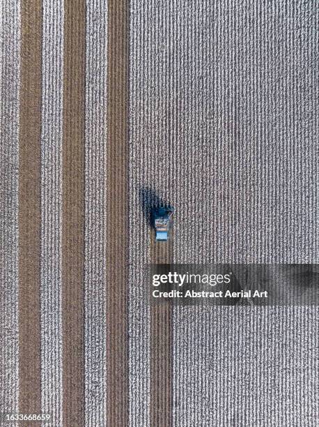 drone photograph looking down on an agricultural machine harvesting a cotton field, queensland, australia - cotton stock pictures, royalty-free photos & images