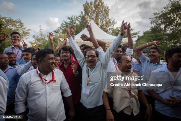 Employees of the Indian Space Research Organisation celebrate after the successful landing of the Chandrayaan-3 mission on the moon inside the ISRO...