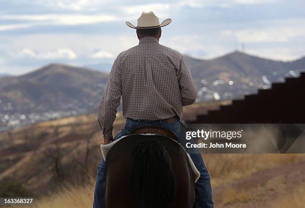 Cattle rancher Dan Bell rides through his ZZ Cattle Ranch at the U.S.-Mexico border fence on March 8, 2013 in Nogales, Arizona. Bell, a third...