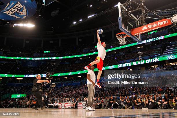 Chase Budinger of the Houston Rockets jumps over entertainer Sean "P.Diddy" Combs during the Sprite Slam Dunk Contest part of 2012 NBA All-Star...