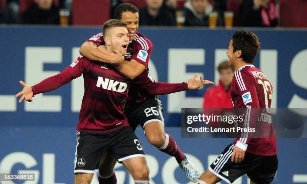 Alexander Esswein, Timothy Chandler and Hiroshi Kiyotake of Nuernberg celebrate a goal during the Bundesliga match between FC Augsburg and 1. FC...