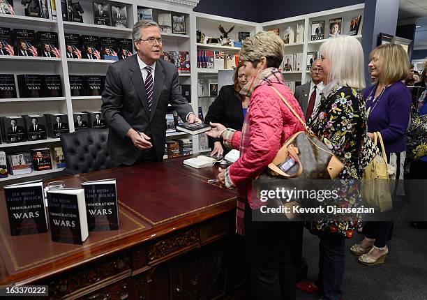 Former Florida governor Jeb Bush autographs his new book "Immigration Wars: Forging an American Solution" before speaking at the Reagan Library about...