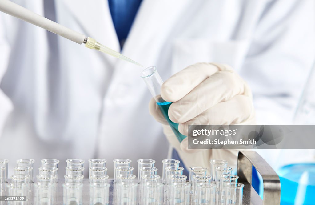 Lab technician taking samples with pipette