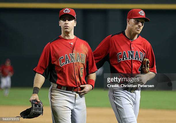 Taylor Green and Pete Orr of Canada walk off the field after being defeated by Italy in the World Baseball Classic First Round Group D game at Chase...