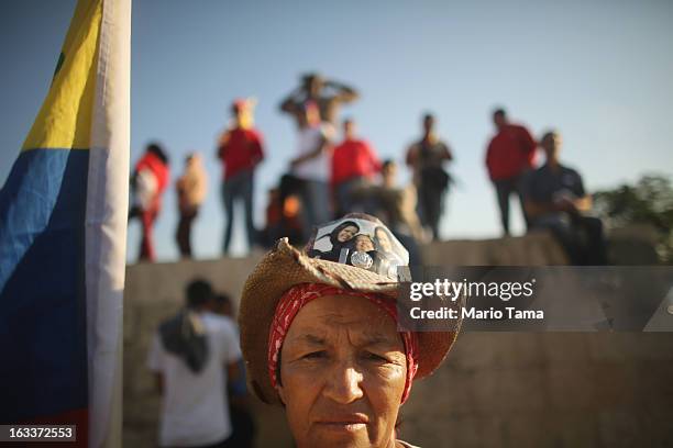 People await the start of the funeral for Venezuelan President Hugo Chavez outside the Military Academy on March 8, 2013 in Caracas, Venezuela....