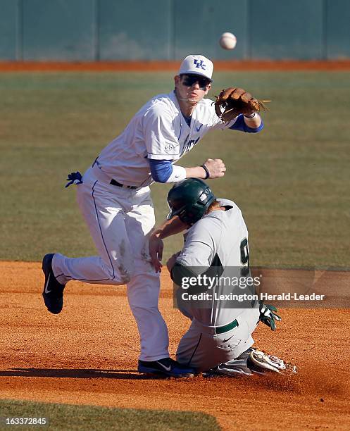 Kentucky second baseman J.T. Riddle forces Michigan State's Jimmy Pickens at second base on the front end of an inning-ending double play in the...