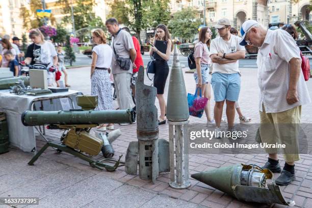 People look at remnants of Russian drones and missiles displayed on Khreschatyk Street during an exhibition on August 22, 2023 in Kyiv, Ukraine....