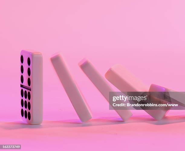 dominoes falling - domino stock pictures, royalty-free photos & images