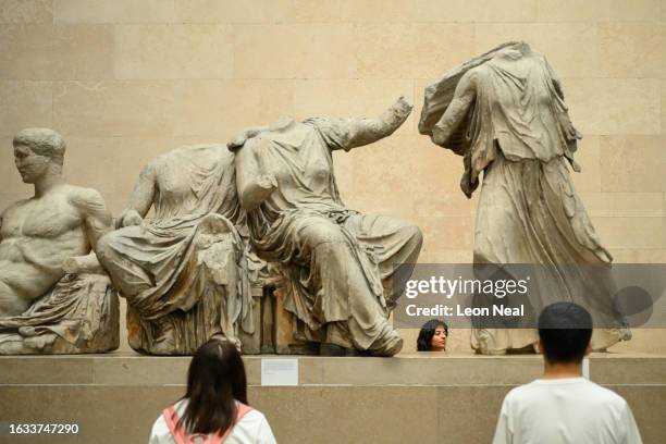 Visitors to the British Museum walk around a selection of items from the collection of ancient Greek sculptures known as The Elgin Marbles on August...