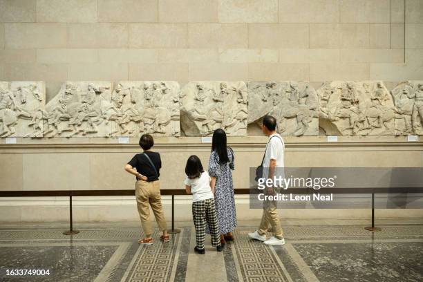 Visitors to the British Museum walk around a selection of items from the collection of ancient Greek sculptures known as The Elgin Marbles on August...