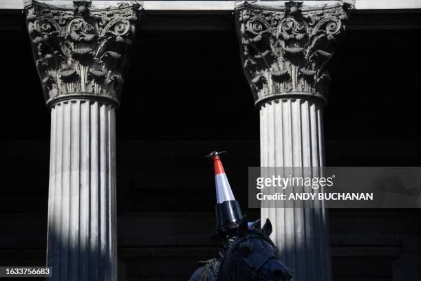 The Duke of Wellington statue is seen with a new cone on its head and another under its arm outside the Gallery of Modern Art in Glasgow on August 30...