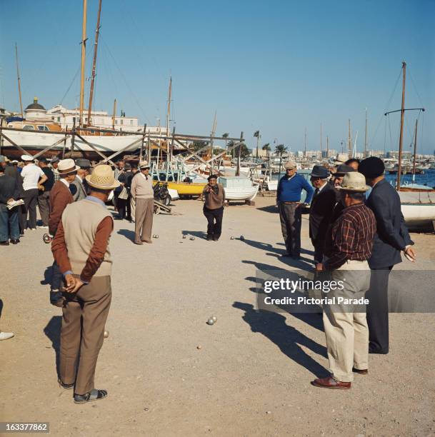 Group of men playing petanque in Cannes, France, circa 1970.