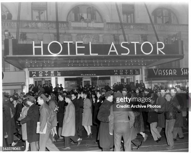 New Year's celebrants walking outside of the Waldorf Astoria on Broadway in New York City, 1946.