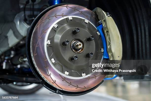 disc brake of the vehicle for repair, in process of new tire replacement. - freno foto e immagini stock