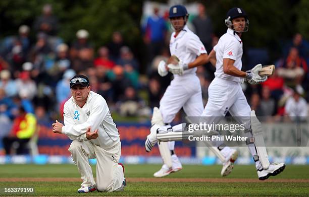 Brendon McCullum of New Zealand watchs the ball travel to the boundary as Alastair Cook and Nick Compton of England make runs during day four of the...