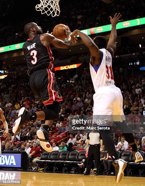 Guard Dwyane Wade of the Miami Heat drives against Guard Charles Jenkins of the Philadelphia 76ers at American Airlines Arena on March 8, 2013 in...