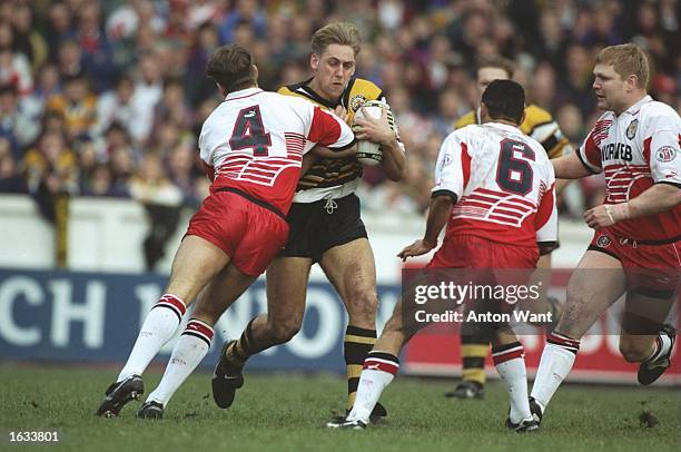 Simon Middleton of Castleford is blocked by the Wigan defence during the Regal Trophy semi-final at Central Park in Wigan, England. Wigan won the...