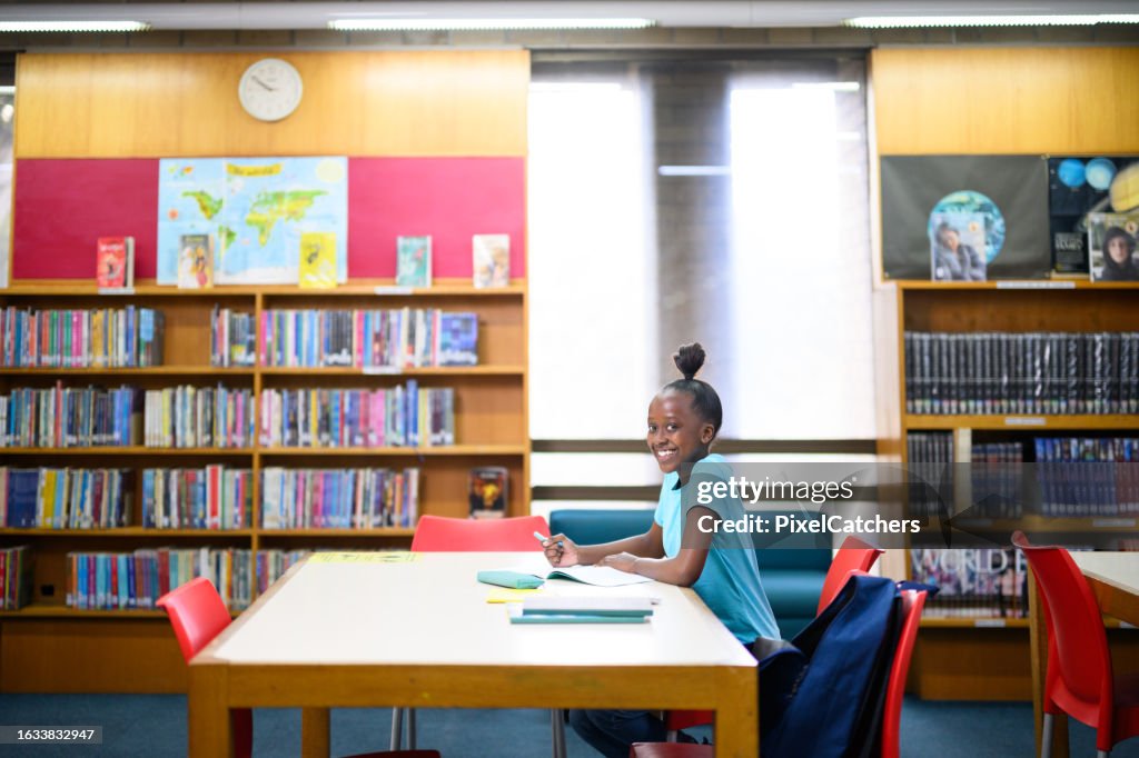 Library Do Homework Wide Shot Side View Candid Portrait Teenage Girl Doing Her Homework In ...