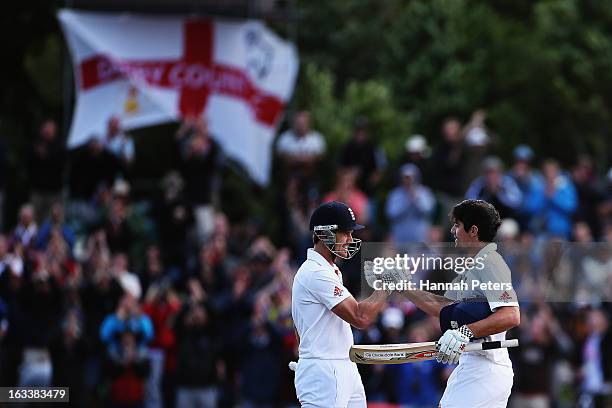 Nick Compton congratulates Alastair Cook of England on his century during day four of the First Test match between New Zealand and England at...