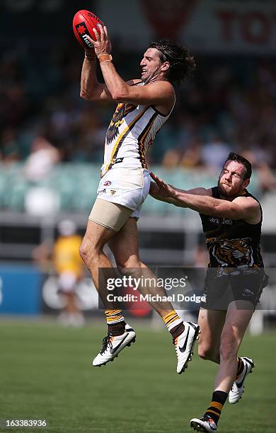 Matthew Spangher of the Hawthorn Hawks marks the ball in front of Jake Batchelor of the Richmond Tigers during the round three NAB Cup AFL match...