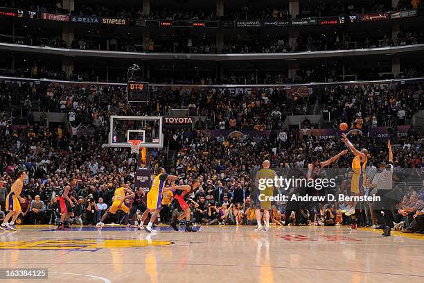 Kobe Bryant of the Los Angeles Lakers makes a three-pointer to tie the game and force overtime against the Toronto Raptors at Staples Center on March...