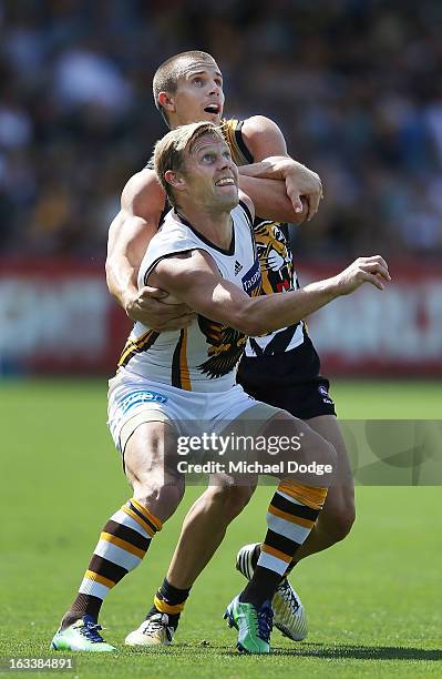 Sam Mitchell of the Hawthorn Hawks contests for the ball against Brett Deledio of the Richmond Tigers during the round three NAB Cup AFL match...