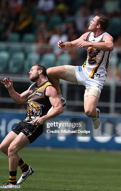 Jarryd Roughead of the Hawthorn Hawks jumps for the ball against Jake Batchelor of the Richmond Tigers during the round three NAB Cup AFL match...