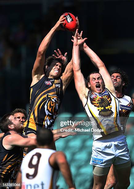 Ben Griffiths of the Richmond Tigers marks the ball against Jarryd Roughead of the Hawthorn Hawks during the round three NAB Cup AFL match between...