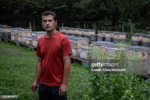 Beekeeper Ibrahim Kahya poses for a portrait in front of his box hives on August 17, 2023 in Macahel, Turkey. Macahel, an area of villages on the...
