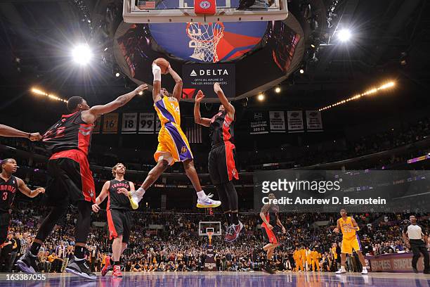 Kobe Bryant of the Los Angeles Lakers goes up for the go-ahead dunk in overtime against DeMar DeRozan of the Toronto Raptors at Staples Center on...