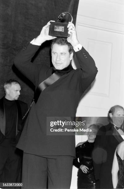 Garth Brooks, John Travolta, Sandy Mahl, and Mike Medavoy attend the 12th annual American Cinematheque Moving Picture Ball at the Beverly Hilton...