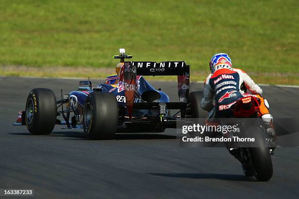 Mark Webber of Australia and Infiniti Red Bull Racing and Casey Stoner of Red Bull Pirtek Holden drive during the Top Gear Festival at Sydney...