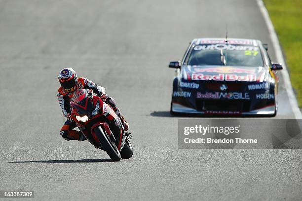 Casey Stoner of Red Bull Pirtek Holden and Jamie Whincup of Red Bull Racing Australia Holden drive during the Top Gear Festival at Sydney Motorsport...