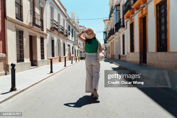 rear view of young asian woman discovering street in the old town - weekender stock pictures, royalty-free photos & images