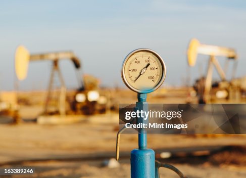 Air pressure gauge, oil rigs in background, Sunset-Midway oil fields, the largest in California.