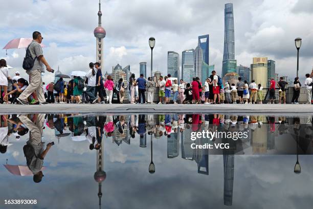 Tourists visit the Bund with skyscrapers at the Lujiazui Financial District in the background on August 23, 2023 in Shanghai, China.