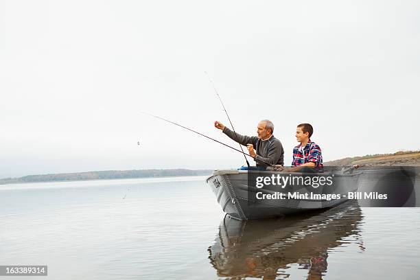 a day out at ashokan lake. a man and a teenage boy fishing from a boat. - lagos state fotografías e imágenes de stock