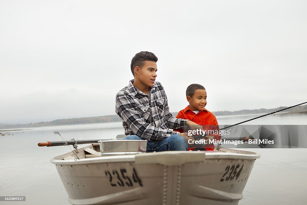 A day out at Ashokan lake. Two boys sitting fishing from a boat.