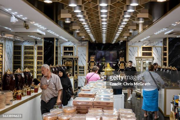 People shop for Turkish honey products at a high-end honey shop on August 23, 2023 in Istanbul, Turkey. Turkey is the world's second largest honey...