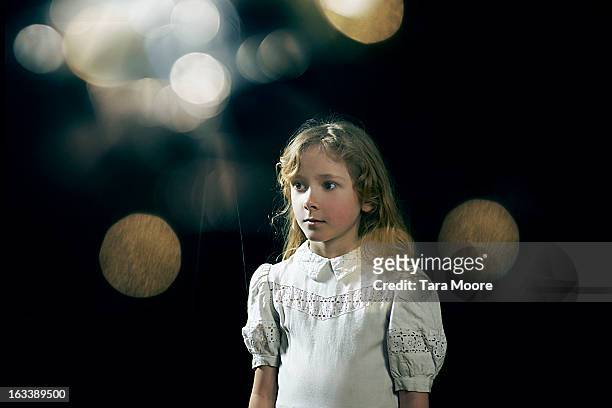young girl standing under light with lens flare - girl white dress stock pictures, royalty-free photos & images