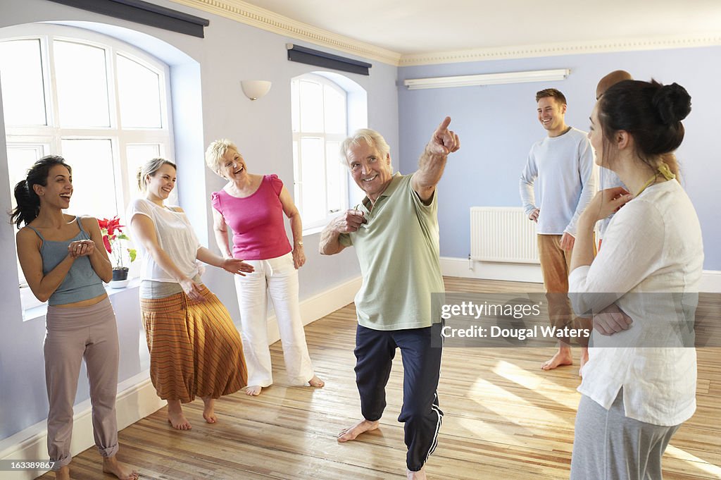 Group of people laughing and playing together.