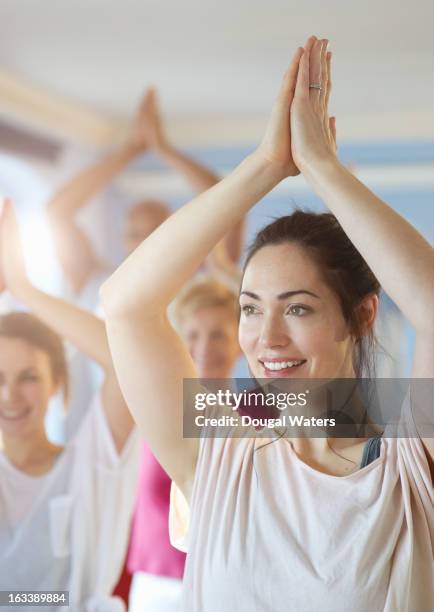 woman smiling with hands above head - girl yoga stock pictures, royalty-free photos & images