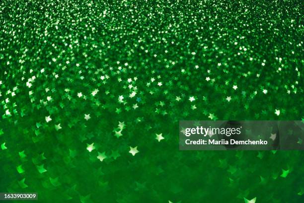 green sparkling glitter stars bokeh lights background - emerald green stock pictures, royalty-free photos & images